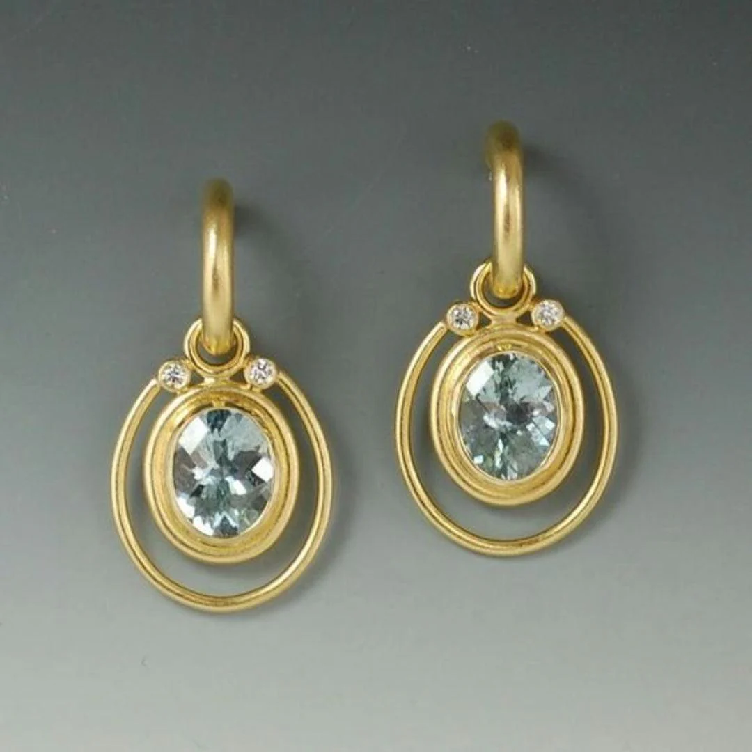 Golden vintage earrings with blue crystal inlay